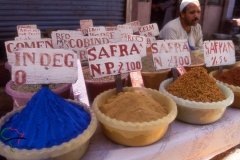 Street vendor selling spices at a souk in Luxor, Egypt