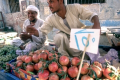Street vendor selling fruit in a souk in Luxor, Egypt