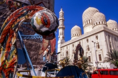 Carnival rides in front of the El-Mursi Abul Abbas Mosque Alexandria, Egypt