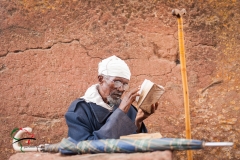 Elderly man reading a book