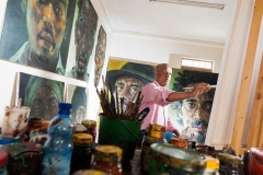 Artist painting in his studio