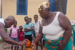 A man giving a woman food  in Labadi, Ghana