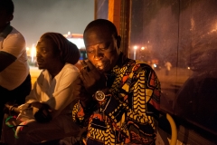 Musician Atongo Zimba lighting a cigarette in Accra, Ghana