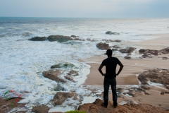 Man standing on a beach in Cape Coast, Ghana