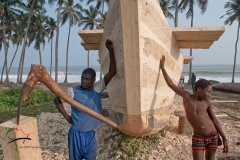 Two boatwrights leaning against a boat, in Accra, Ghana