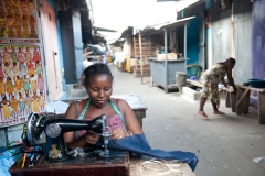 Seamstress mending clothing in Cape Coast, Ghana