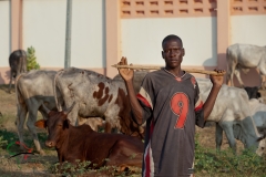 Portrait of a man holding a stick in Tema, Ghana