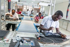 Men working on a computer assembly line, in Accra, Ghana