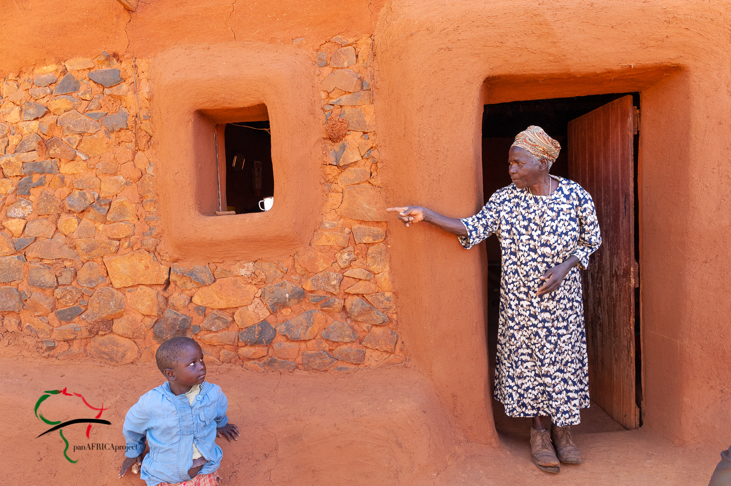 Elderly woman and child outside of their house