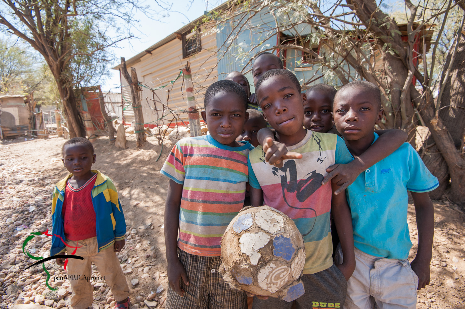 Portrait of children holding a soccer ball.