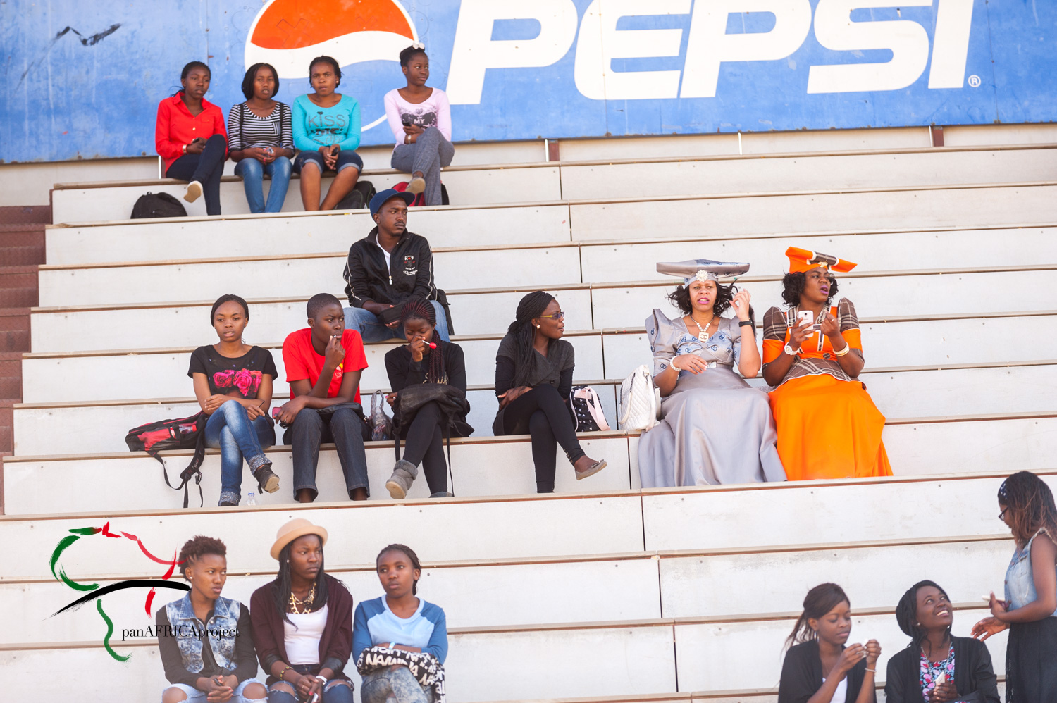 Spectators sitting on a grandstand.