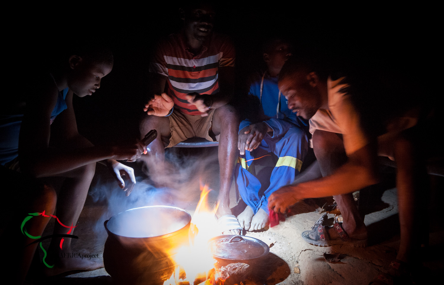 Men from the Herero Tribe cooking with an open flame.