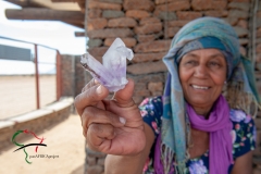 A crystal vendor holding a crystal.