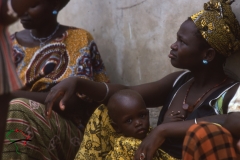 Mother sitting with her child in Ngor, Senegal