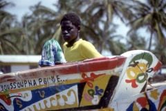 Man on a boat in a fishing village in Joal-Fadiouth, Senegal