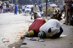 Men kneeling for prayer in Dakar, Senegal
