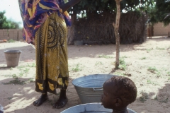 Mother bathing her child in Dakar, Senegal