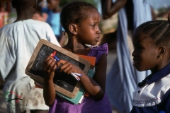Girl holding school supplies in Dakar, Senegal