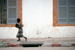 School girl running in Saint Louis, Senegal