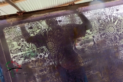 Artist standing behind a  silk screen