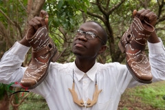 Artist holding up decorated boots