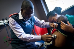 Doctor using a stethoscope on child patient