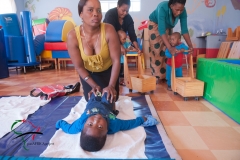 Mother helping child with cerebral palsy