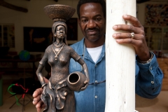 Artist standing with sculpture