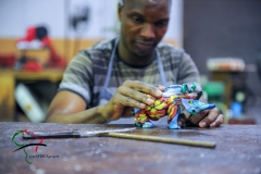 Factory worker making a candle