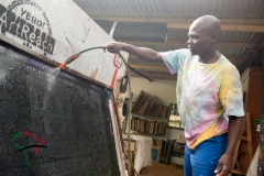 Artist washing a silk screen