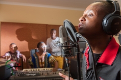 Hip hop musician recording a song in a studio