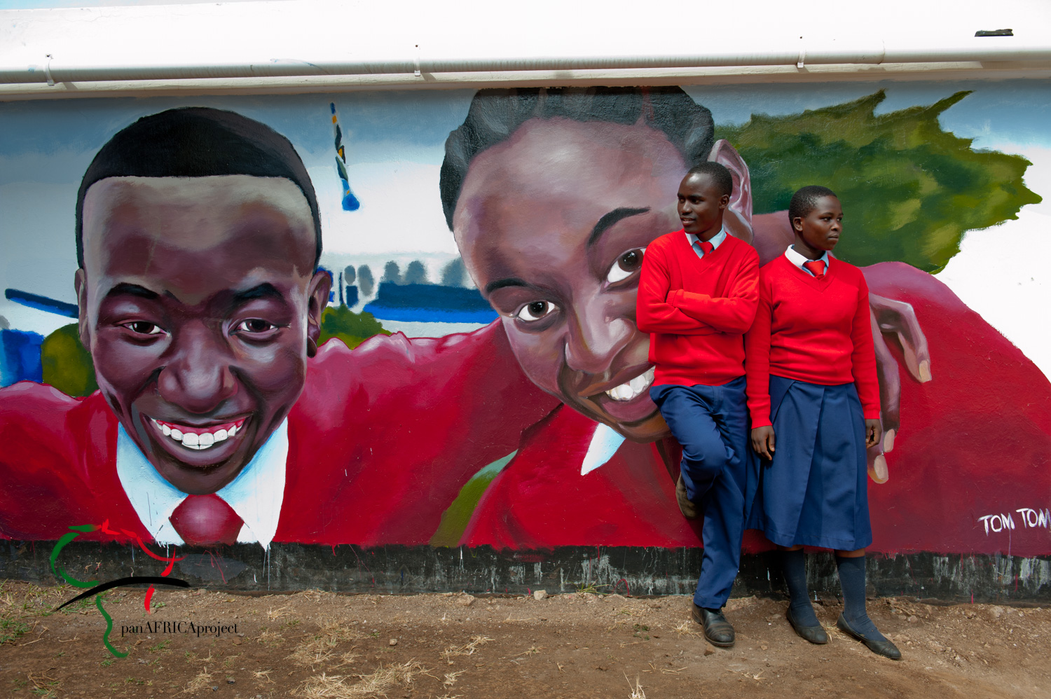 Two students standing in front of a mural