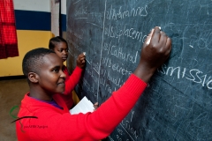 Students writing on a black board