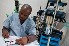 A medical technician writing in a journal