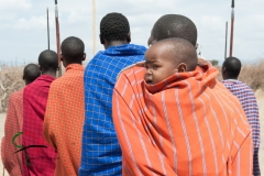 A child being carried on the back of his mother