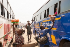 Vendors selling products in between buses