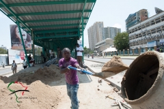 A man shoveling sand