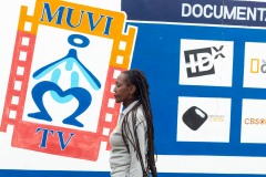 Woman walking in front of Muvi TV station