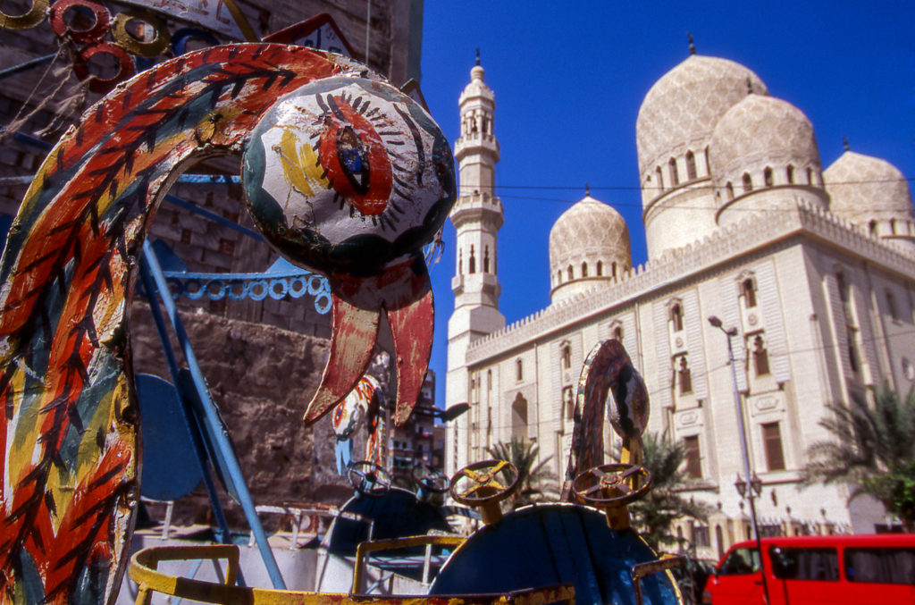 Carnival rides in front of the El-Mursi Abul Abbas Mosque