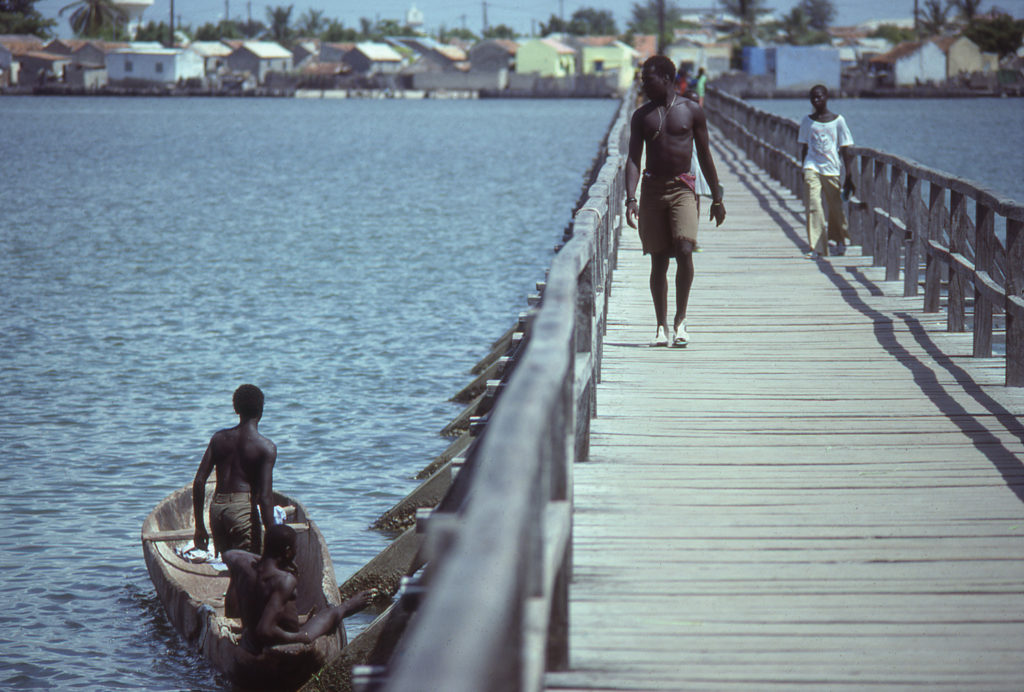 People walking on the bridge to Joal-Fadiouth