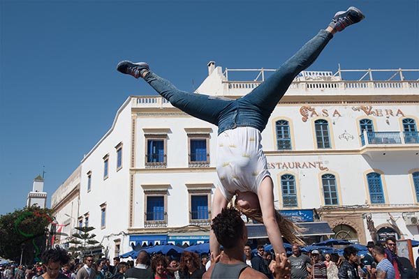 Buskers performing acrobatics for spectators at the Gnaoua World Music Festival