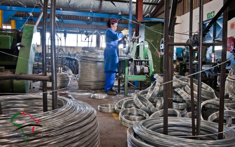 Female factory worker cutting steel wire