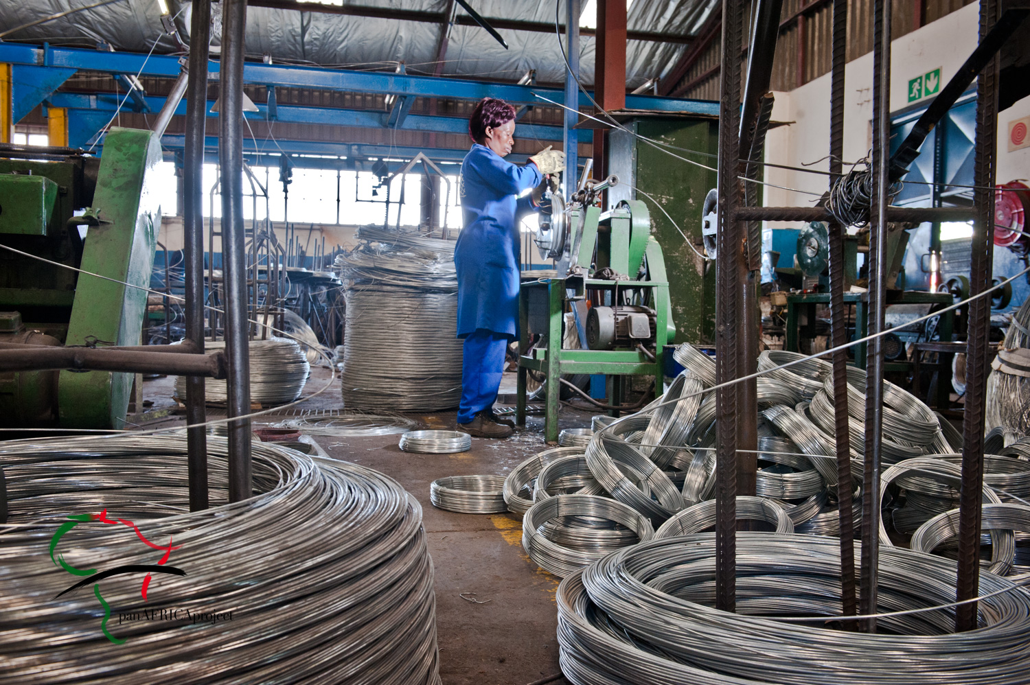 Female factory worker cutting steel wire